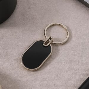 01_151642c1-1310-4b5a-921b-56460878c36f.jpg Oval Metal Keychain – Elegant Black & Silver Finish for Everyday Use