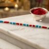 04_e228014f-989e-4c66-8fc9-9eff16a41fdb.jpg Handmade Pearl Beaded Rakhi – Elegant Traditional Gifting