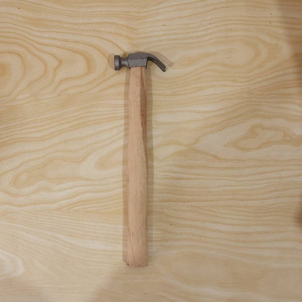 17056-07-live_8f541cb9-6e77-4d02-a6d2-8911a9a70ad2.jpg Wooden Handle Claw Hammer – Durable Steel Head for Carpentry